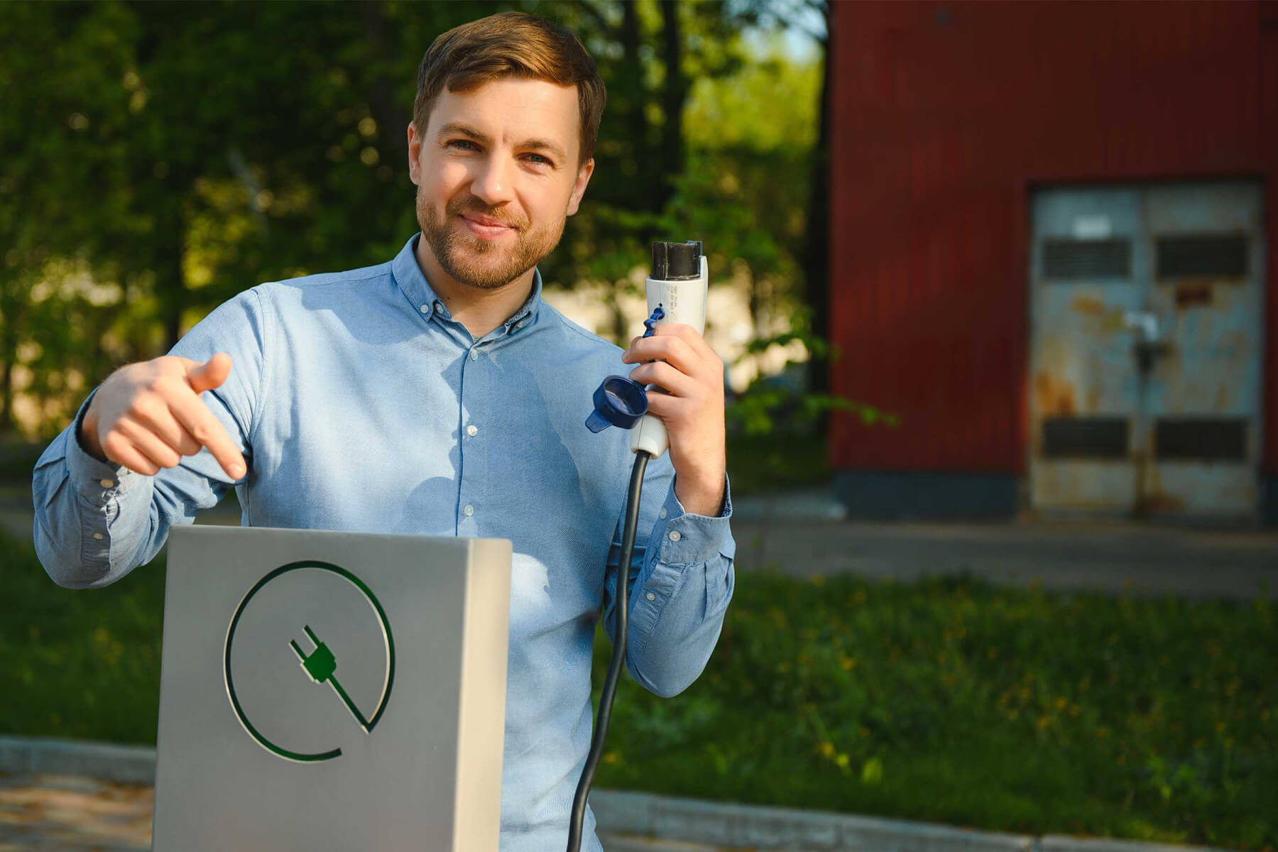 portrait-of-a-young-man-standing-with-charging-cab-G74WGRP.jpg